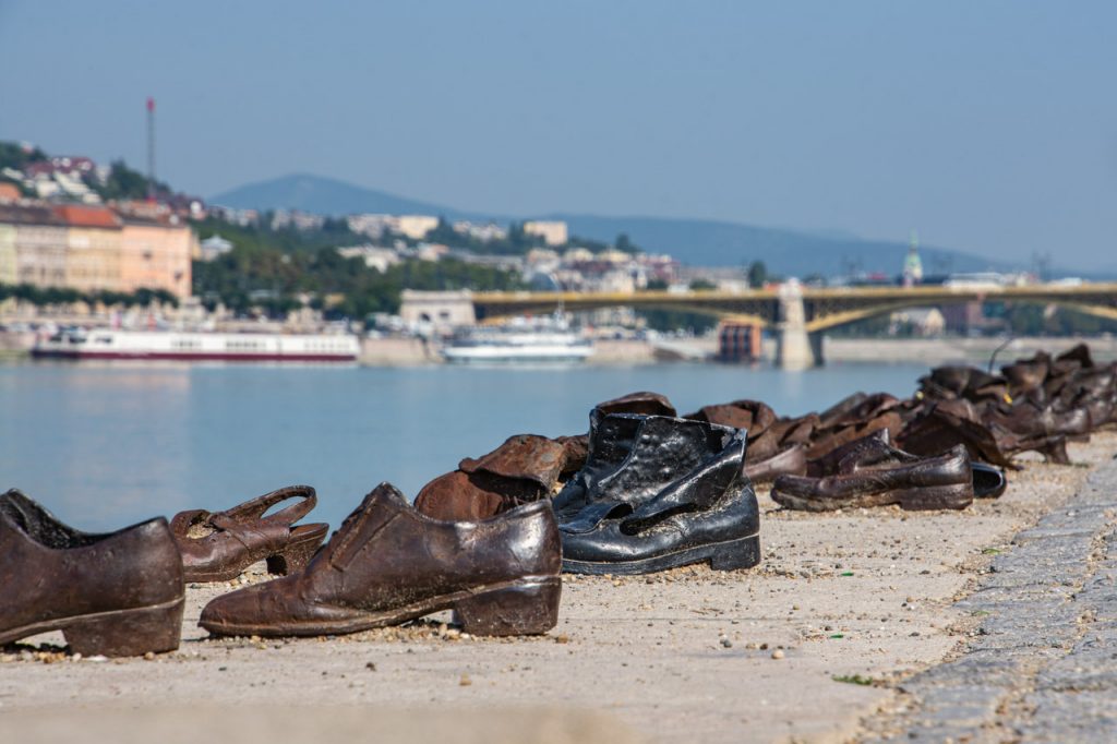 Caste iron shoes on the riverbank with Budapest in the background