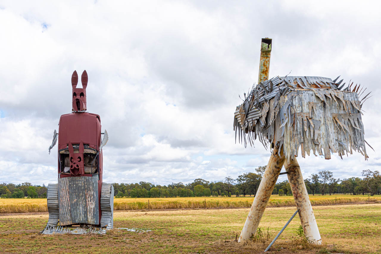 Sculptures in a paddock of a kangaroo and emu made from old car parts and other scrap metal.