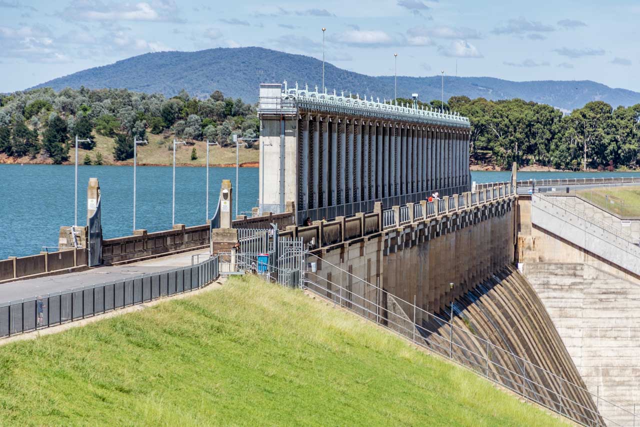A photo of a dam wall with the reservoir behind the wall