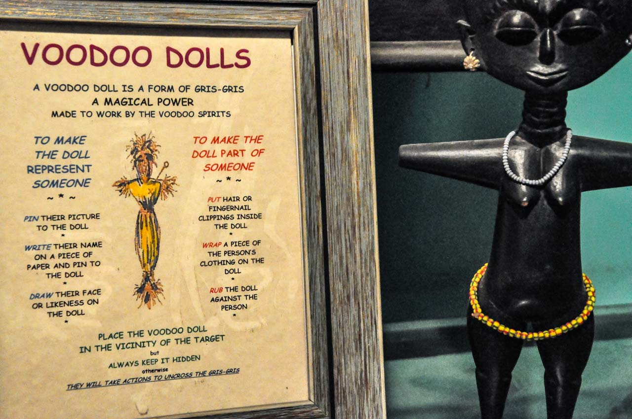 An ebony female image with information on how to use voodoo dolls.