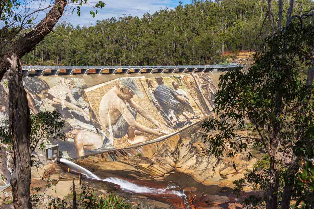 A painting of children and a man on a dam wall