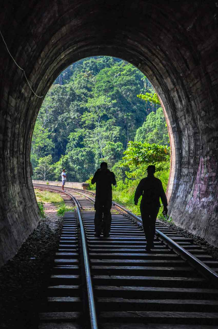 Two people exiting a railway tunnel