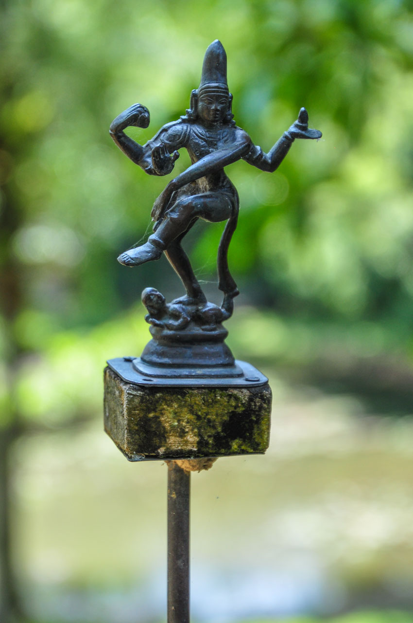 Metal sculpture of a figurine with four arms