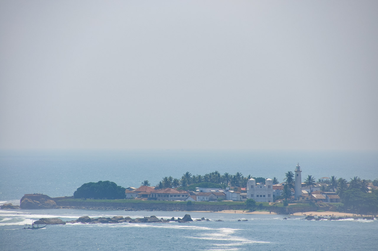 View of a town on a peninsula with colonial buildings and surrounded by ocean