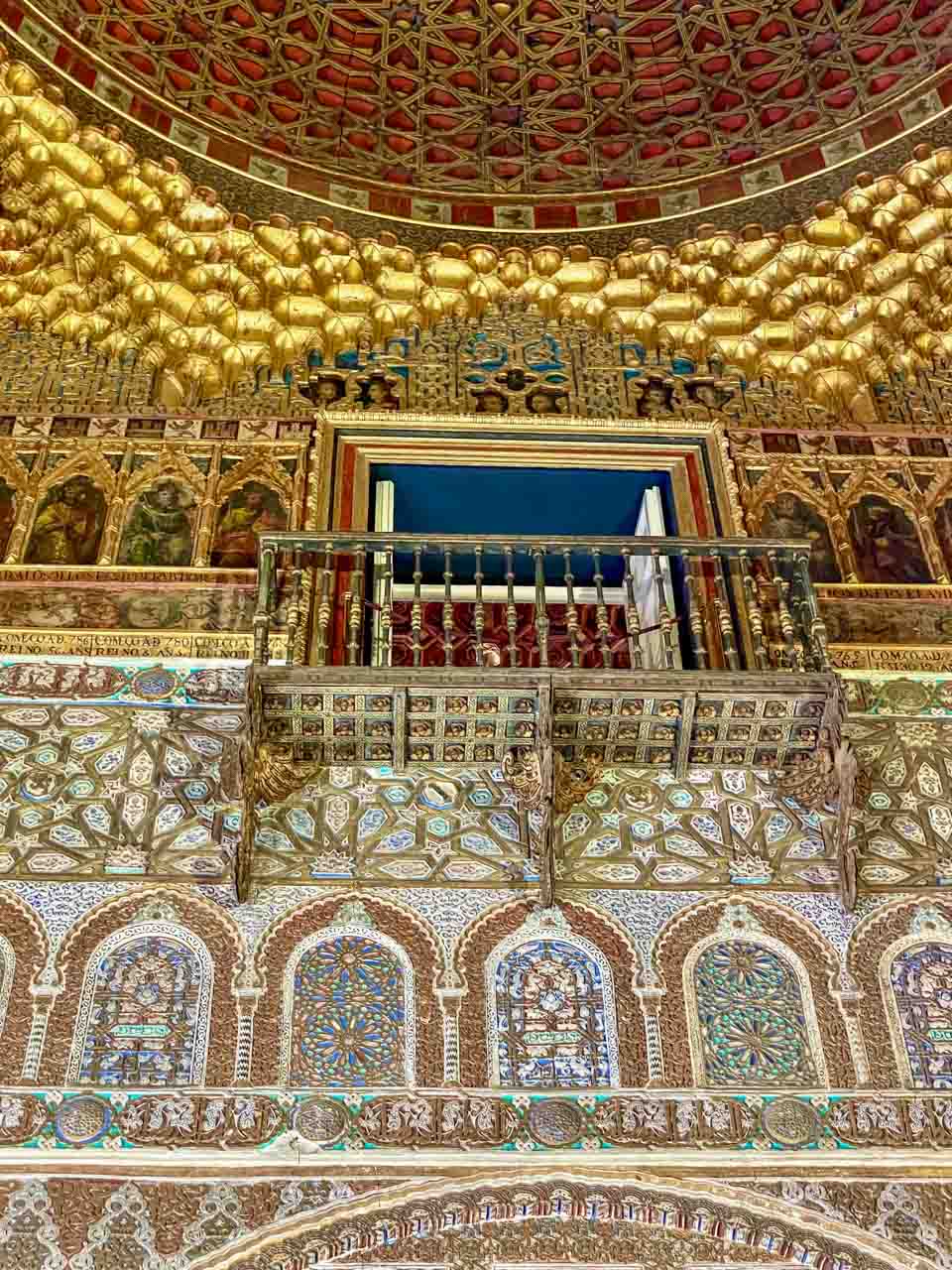 Mosaic walls and ceiling inside a building in the Islamic style of architecture.