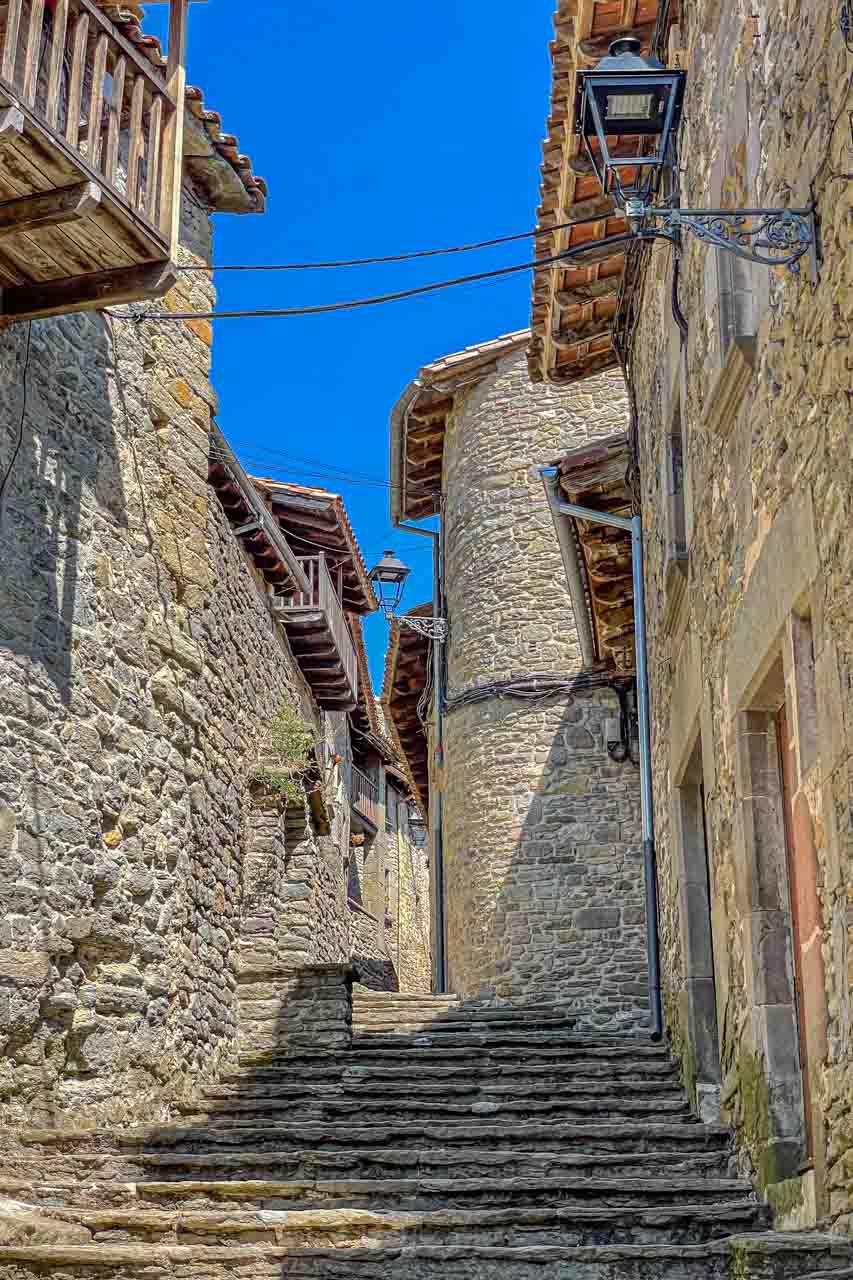 Cobblestone stairs lead through a medieval village of stone houses